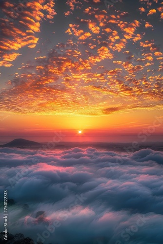 Breathtaking sunset over a sea of clouds with vibrant orange sky