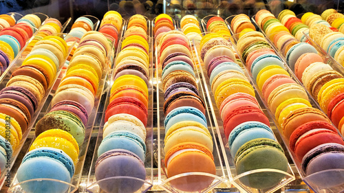Large collection of colorful macarons in a display window