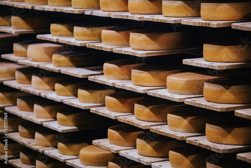 Shelves with wheels of cheese at cheese warehouse