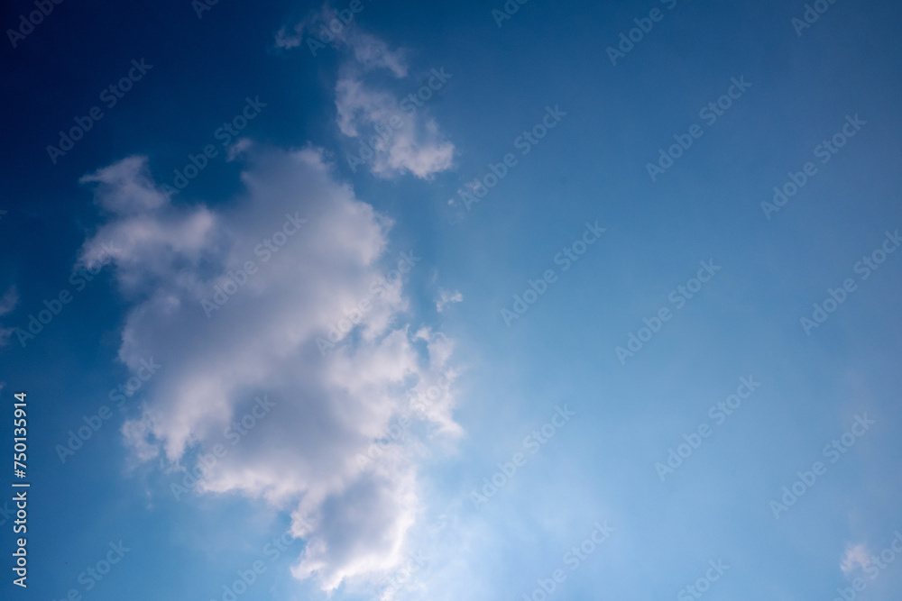 blue sky with white clouds sunray background