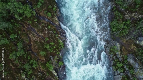 River flowing between mountains in norway. view from drone. 4k