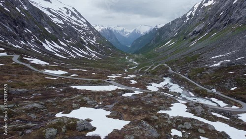 mountain road through a valley with rivers and waterfalls