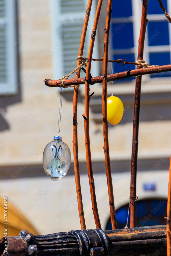 Colorful painted decorative Easter eggs hanging by an iron frame outside