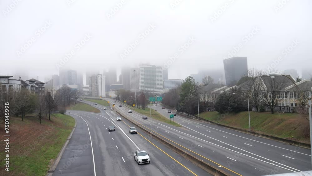 Overcast Cloudy Gloomy Interstate Highway Traffic Cars Exiting and Driving into Foggy City Overcast Cloudy Gloomy Interstate Highway Traffic Cars Exiting and Driving into Foggy City