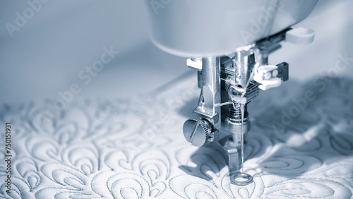 Close-up detail of the sewing machine, Closeup of a modern sewing machine presser foot sewing fabric with thread Used for making clothes curtains and upholstery business hobby and handmade projects. photo