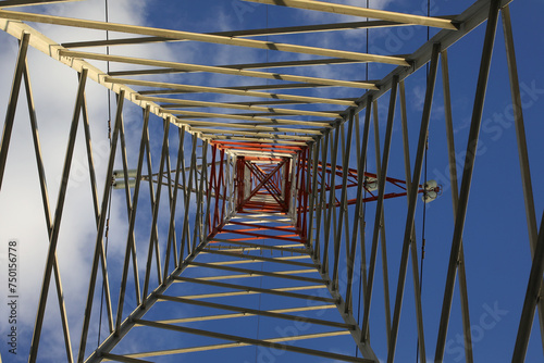 high pylon with high voltage cables for the transport of electricity and clouds on the sky photo