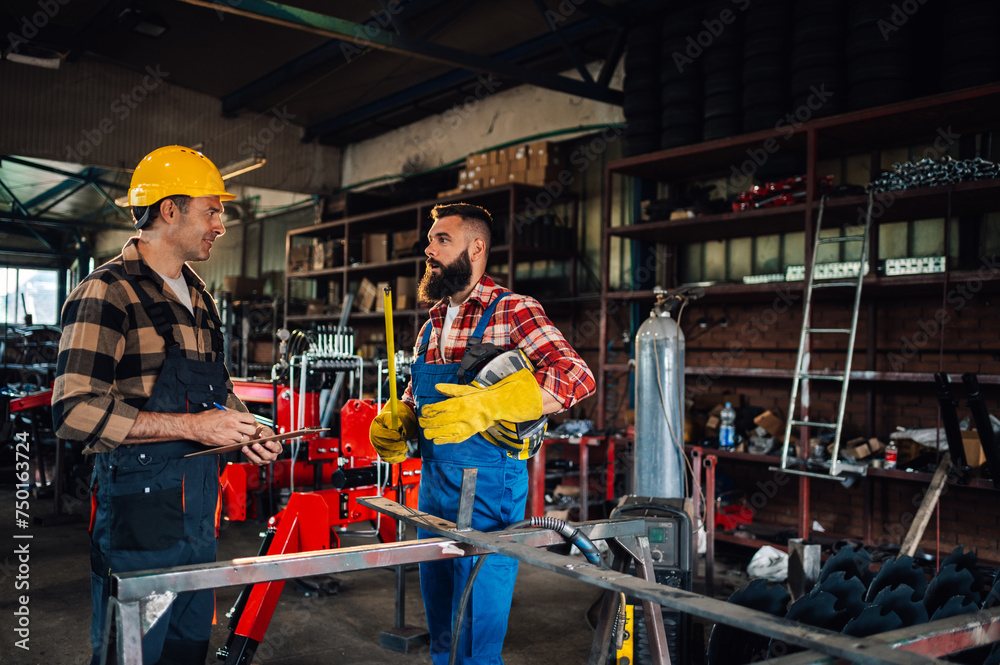 Two coworkers talking about the project while wearing safety gear. Two coworkers talking about the project while wearing safety gear.