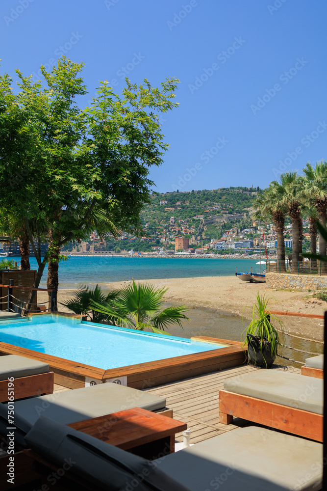 View of the beach and sea with umbrellas and sun loungers, summer sunny day