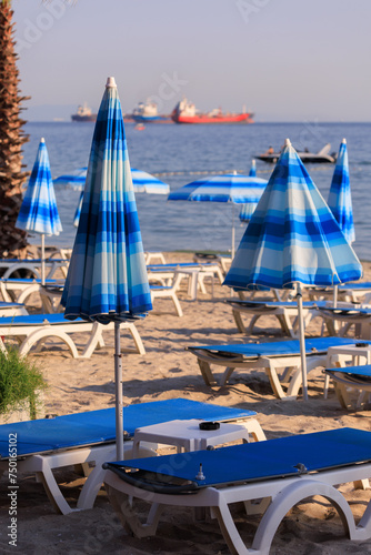 View of the beach and sea with umbrellas and sun loungers, summer sunny day © Kozlik_mozlik