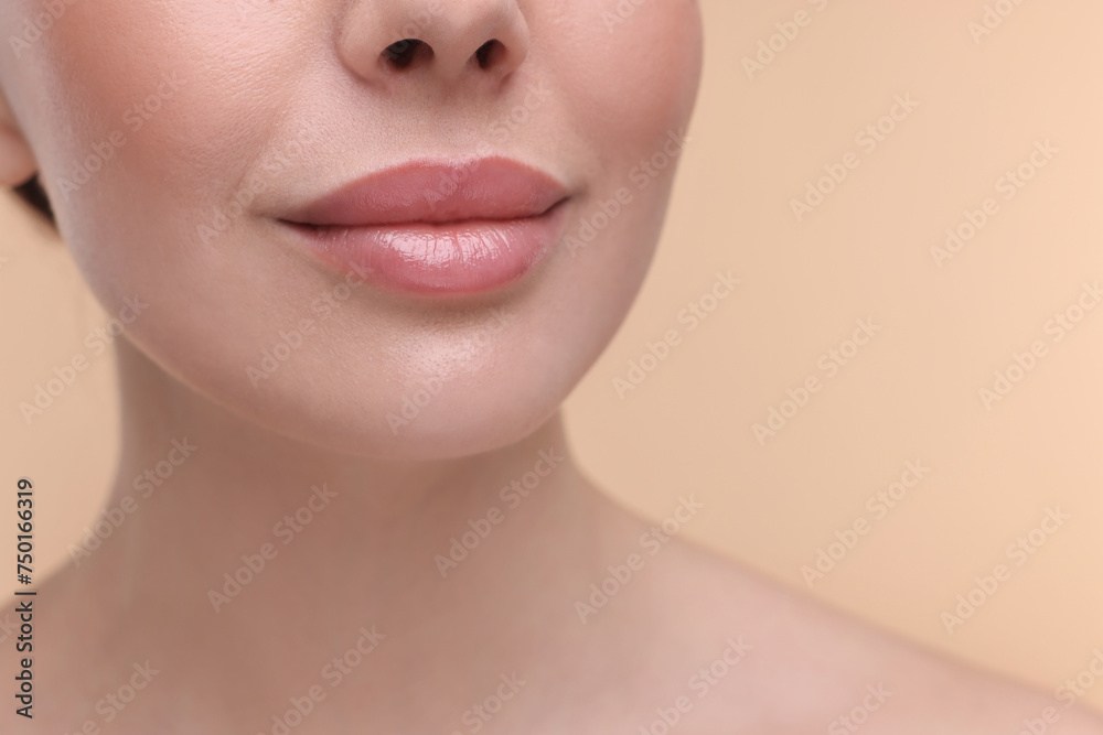Woman with beautiful lips on beige background, closeup Woman with beautiful lips on beige background, closeup