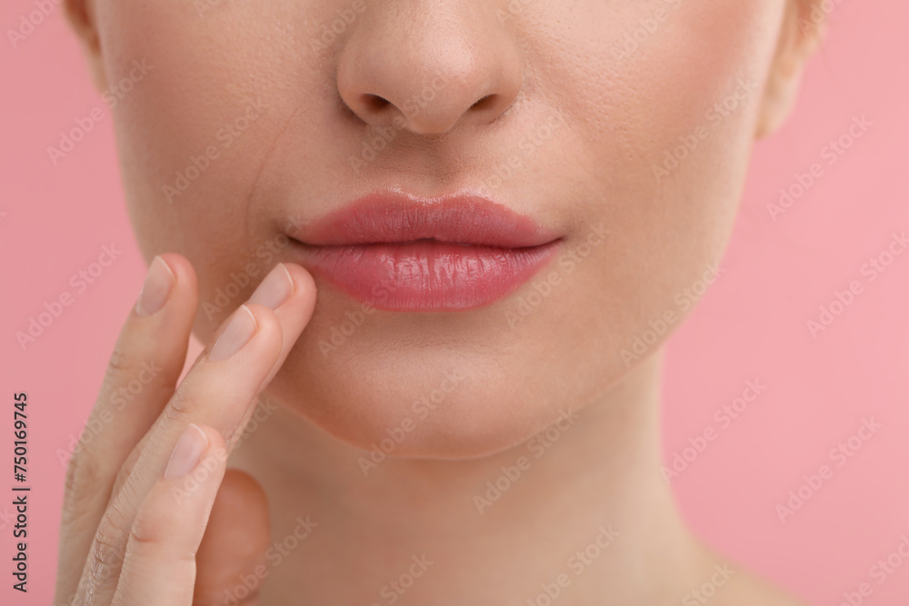 Obraz premium Young woman with beautiful full lips on pink background, closeup
