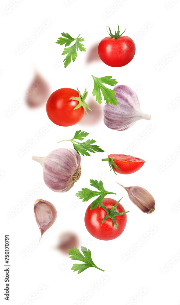 Fresh garlic, tomato and parsley falling on white background Fresh garlic, tomato and parsley falling on white background