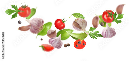 Fresh garlic  peppercorns  tomato and herbs falling on white background