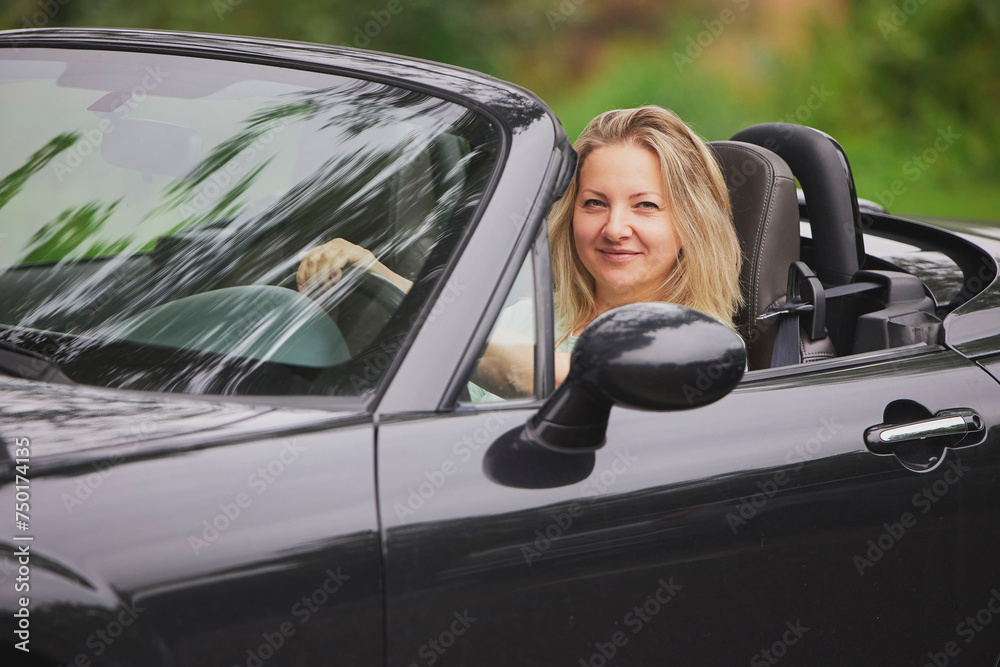 Attractive woman in a cabriolet in the Netherlands