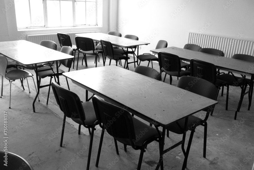 An Empty Desolate Classroom With Empty Desk and Seats