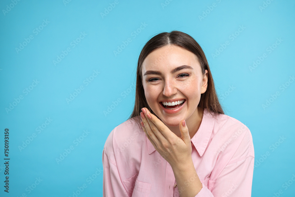 Beautiful woman laughing on light blue background. Space for text Beautiful woman laughing on light blue background. Space for text
