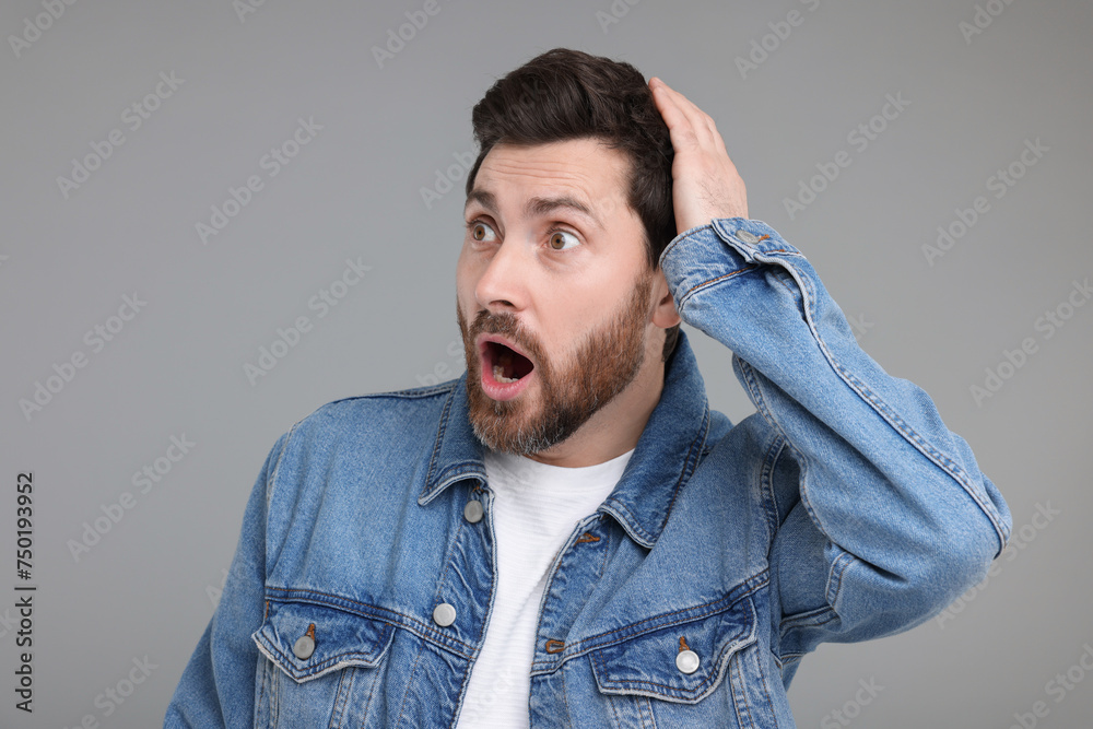 Portrait of surprised man on grey background Portrait of surprised man on grey background