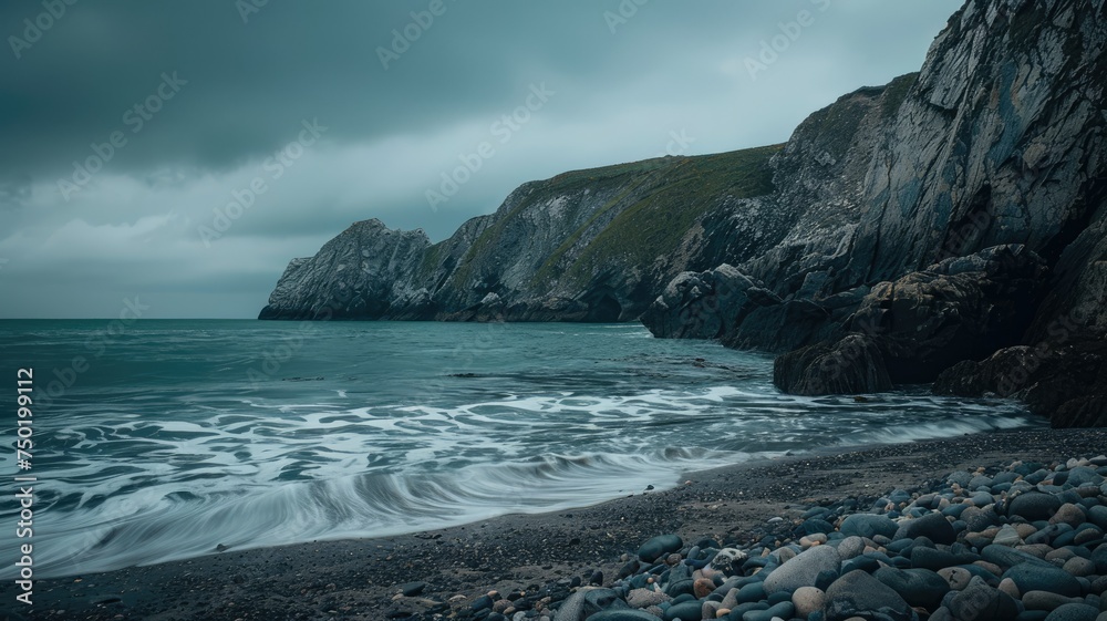 Moody sea cove with cloudy backdrop - A dramatic and moody image of a rugged coastal sea cove under a cloudy, somber sky evoking solitude