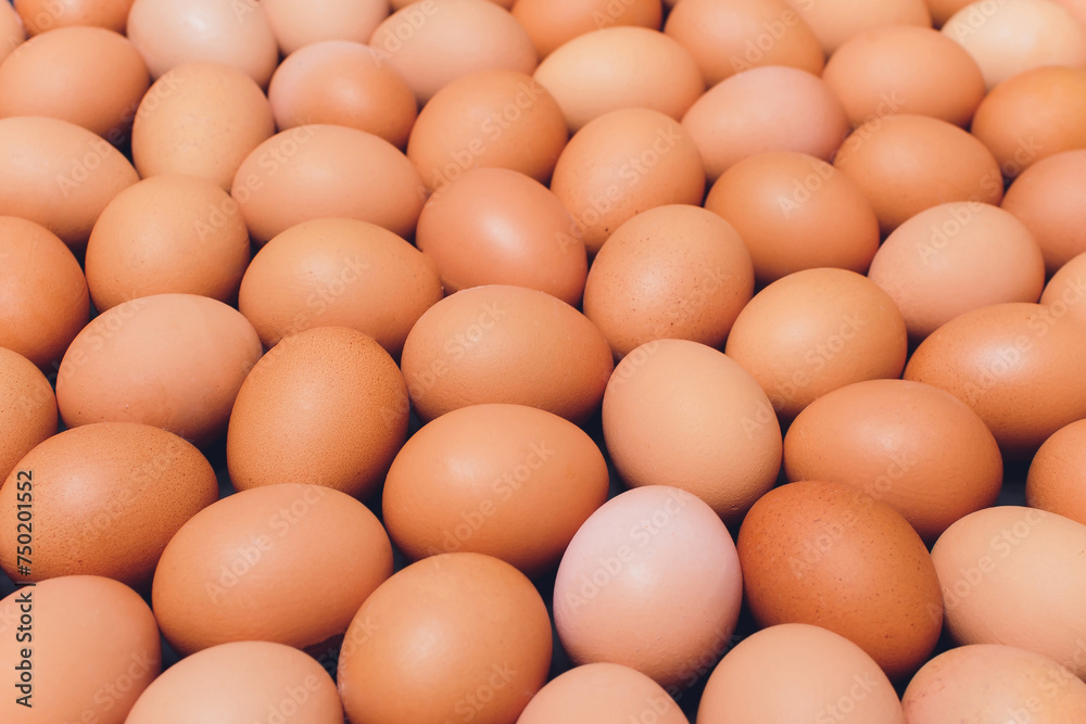 Many eggs lie together on each other, brown eggs, a lot of chicken eggs.
