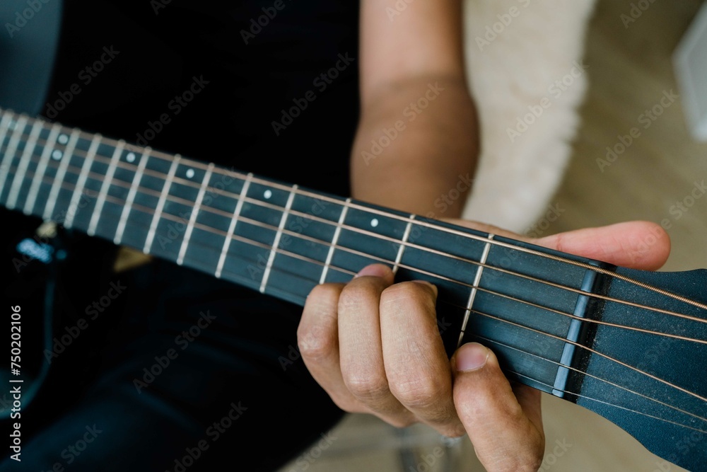 Close up of a man playing acoustic guitar