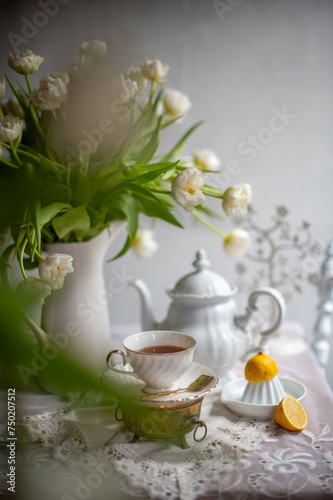 Beautiful still life with white tulips. Vintage style life. Coffee time.
