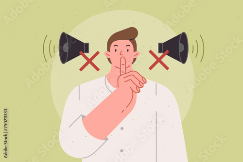 Man makes tss gesture urging him to switch phone to airplane mode and speak in whisper