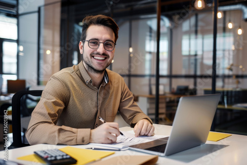 Portrait of young businessman in shirt, man smiling and looking at camera at workplace inside office, accountant with calculator behind paper work signing contracts and financial reports
