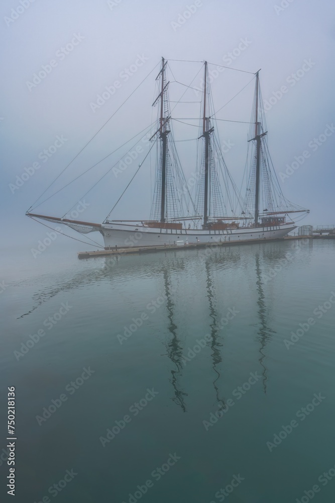 A boat in morning fog on the Toronto harbour front at Lake Ontario in Ontario, Canada