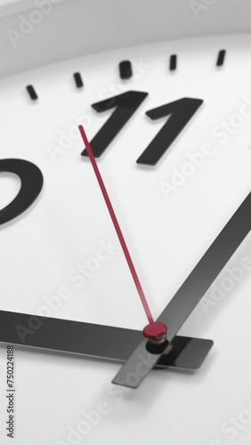 A White Wall Clock With The Time Of 9.00 Am Or Pm. A Black Hands and Red Second Hand Of The Clock, The Concept Of Time. Vertical.