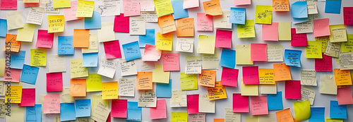 A wall of colorful post-it notes in a variety of colors, conveying a sense of organization, chaos, and creativity.