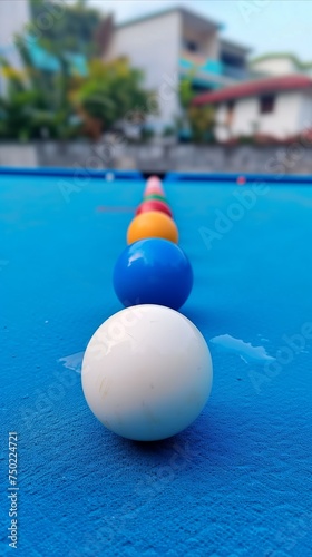 Colorful pool balls in a line on a blue table