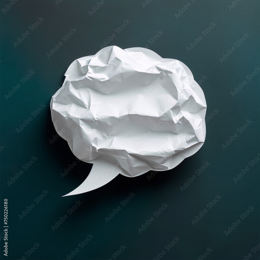 White crumpled paper speech bubble on dark blue background White crumpled paper speech bubble on dark blue background