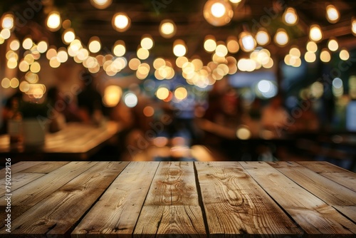 Brown wooden table with blurry restaurant lights and people dining suitable for showcasing products