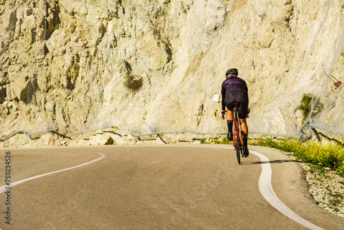Cyclist on road in mountains, Spain