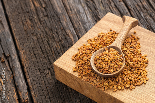 Methi Dana - Dried organic fenugreek seeds in the wooden spoon