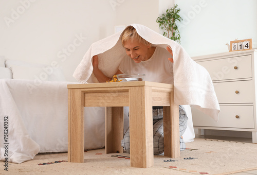Mature woman doing steam in...
