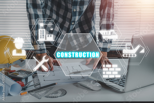 Construction concept, Engineerman working on office desk with construction icon on virtual screen.