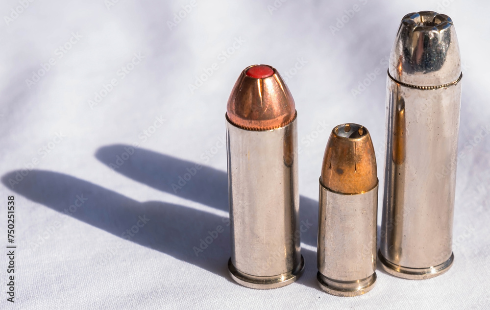 Three hollow point bullets of different calibers on a white background Three hollow point bullets of different calibers on a white background