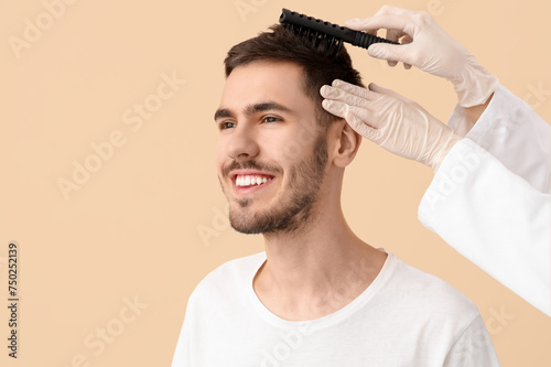 Doctor brushing young man's...