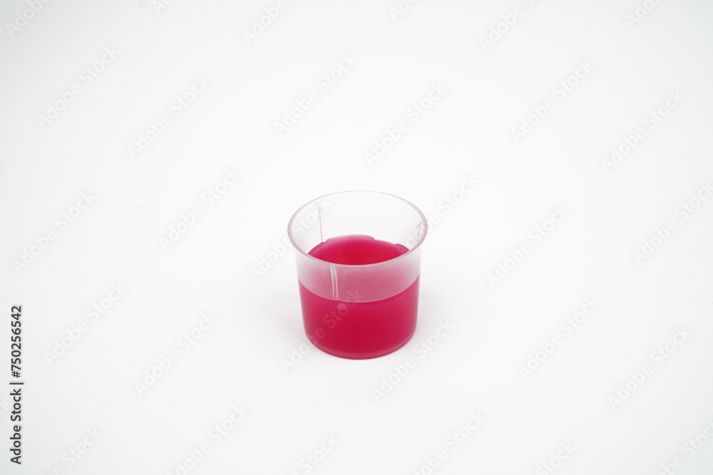 Cough Syrup medicine in a cup concept background Cough Syrup medicine in a cup concept background
