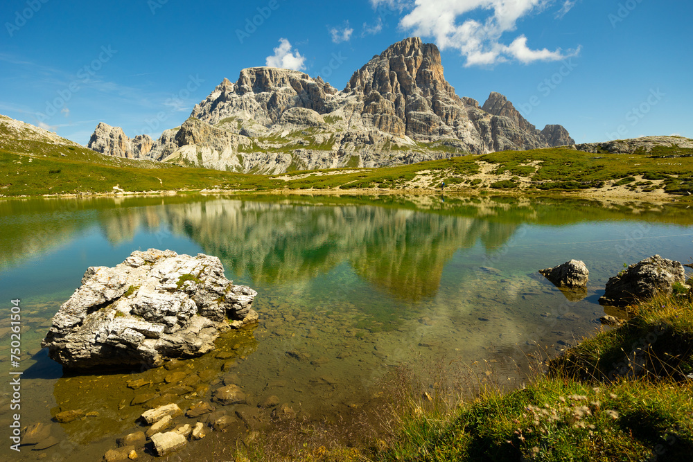 Spectacular scene of small serene natural lakes Bodenseen under summer sun surrounded by greenery and rocky mountains in Sexten Dolomites in South Tyrol, Italy