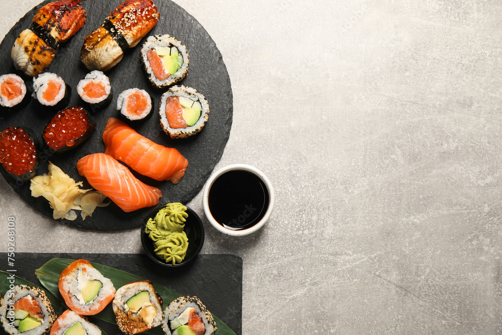 Different tasty sushi rolls on light grey table, flat lay. Space for text Different tasty sushi rolls on light grey table, flat lay. Space for text