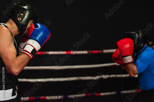 Two boxers face to face with their guard prepared to fight