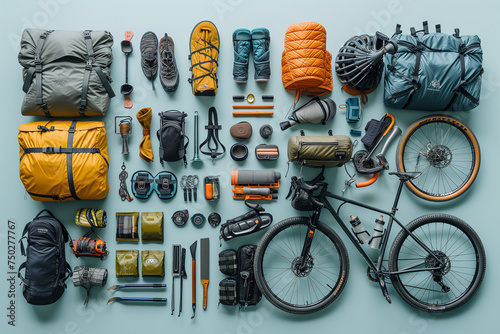 Against a serene light blue backdrop, the essentials of a bikepacking adventure are meticulously laid out in a knolling arrangement