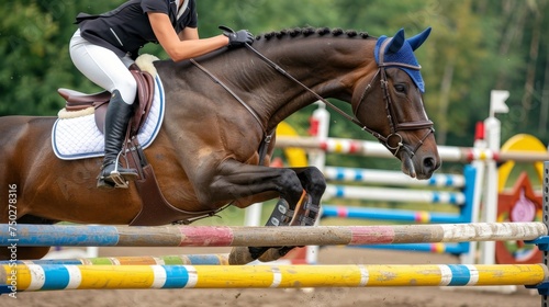 Equestrian rider showing precision and athleticism while jumping in a striking close up view.
