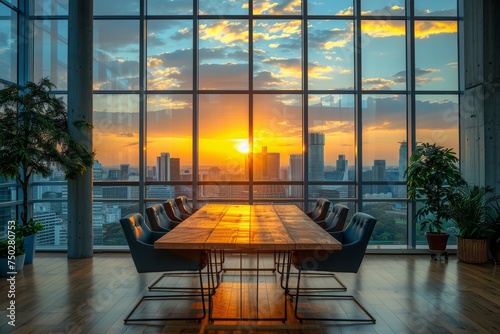 An elegant boardroom with a large wooden table, comfortable chairs, and a breathtaking sunset view over the city photo