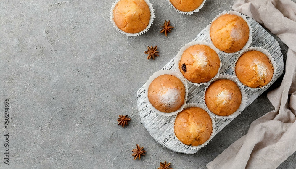 Tasty muffins on gray table, flat lay. Space for text