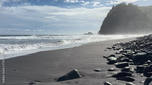 Waves hitting one of Hawaii's black sand beaches, created by lava rocks eroding. photo