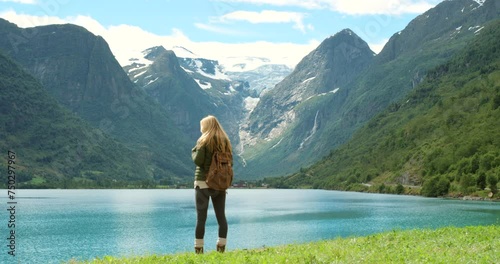 Lake, mountain or woman hiking in nature adventure to explore outdoors for holiday vacation. Tourist thinking, walking or back of hiker trekking in Norway for travel, exercise or journey for view