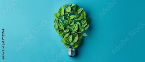 A light bulb, made of green leaves and clipped leaves, is presented on a blue background, showcasing minimalist collages, colorful aesthetics, and a flat composition. photo